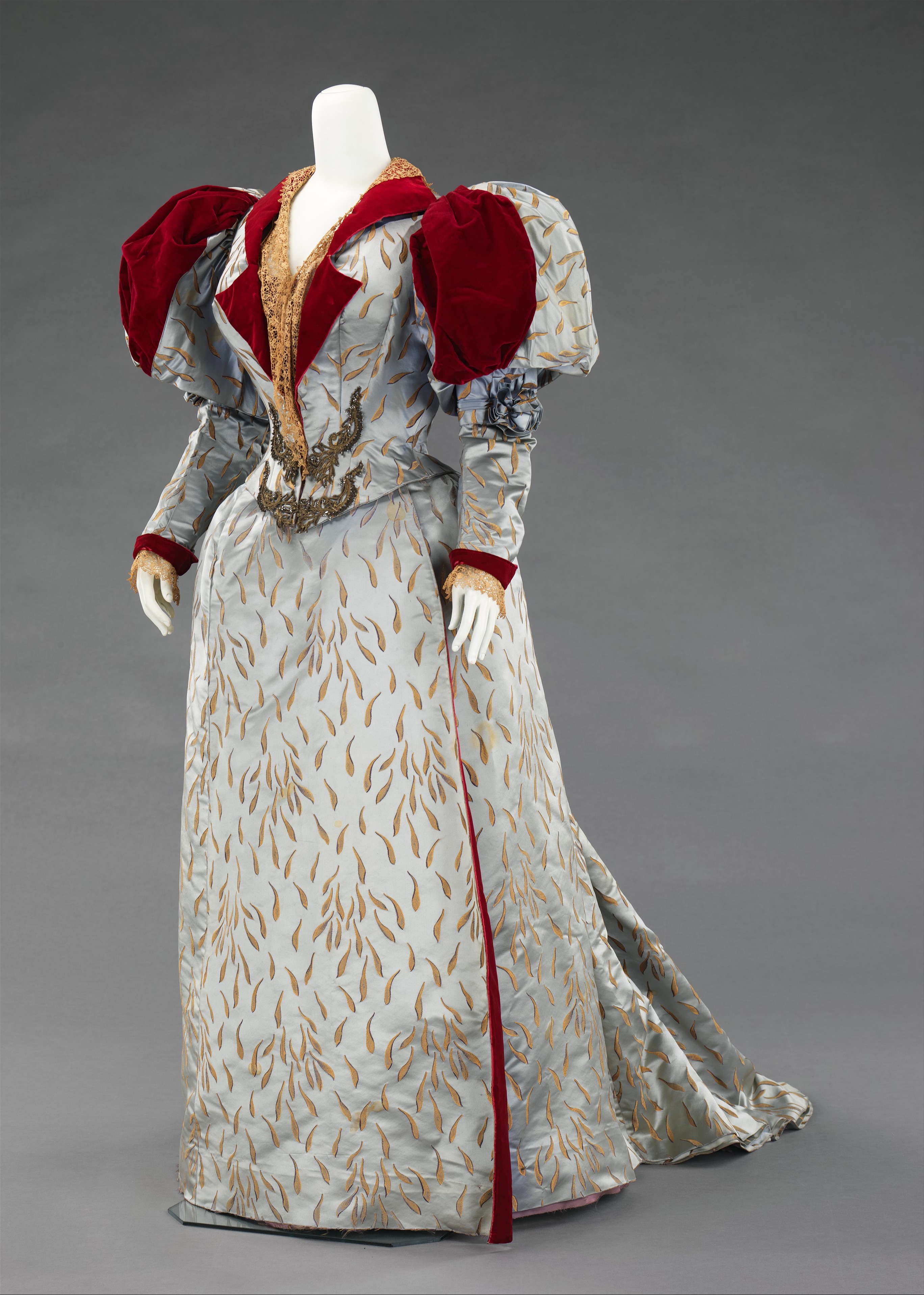 House of Worth evening ensemble from 1893 in silk, linen, and metal, shown from a three-quarter front view.