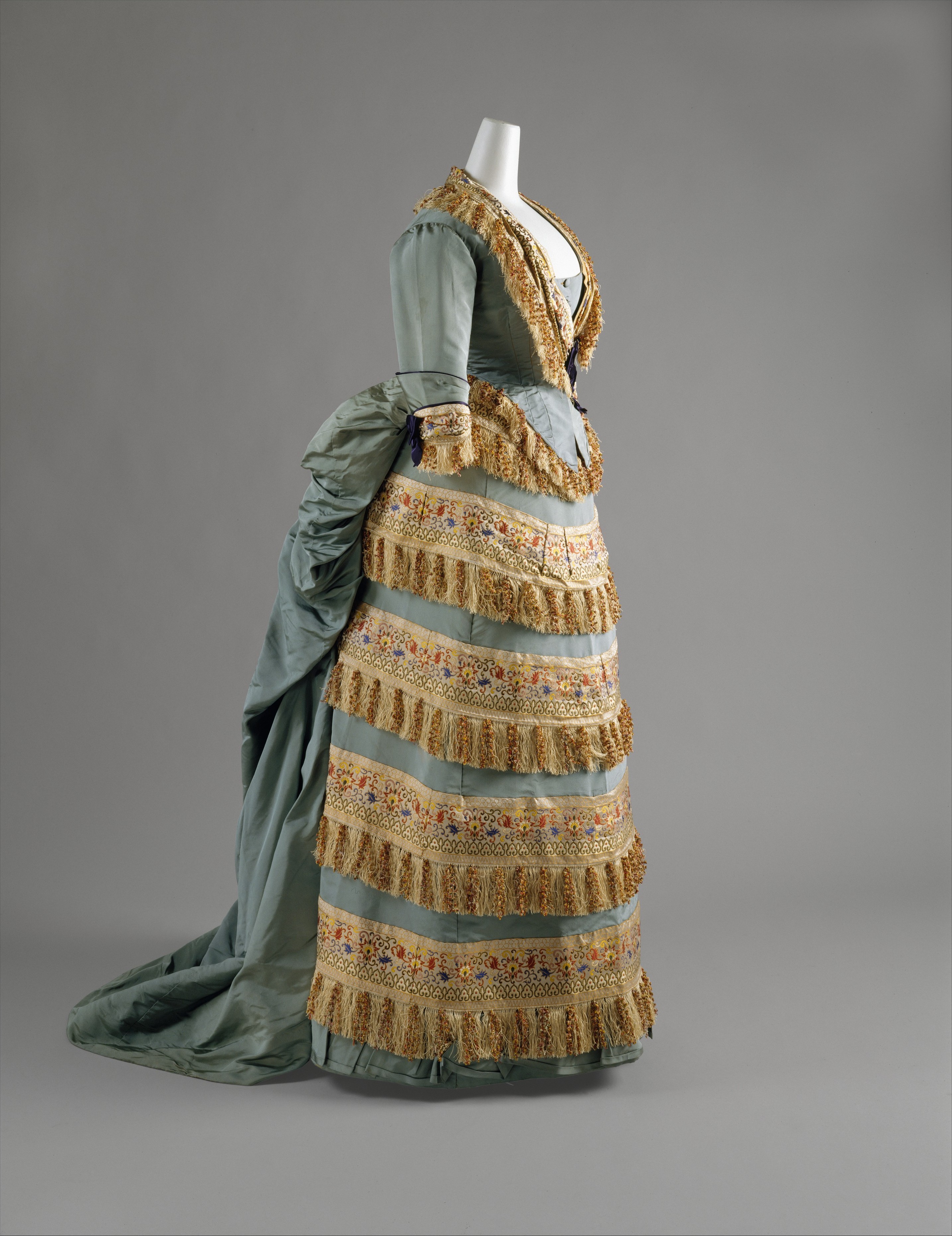 Elaborately trimmed silk ball gown by the House of Worth, dated around 1872.